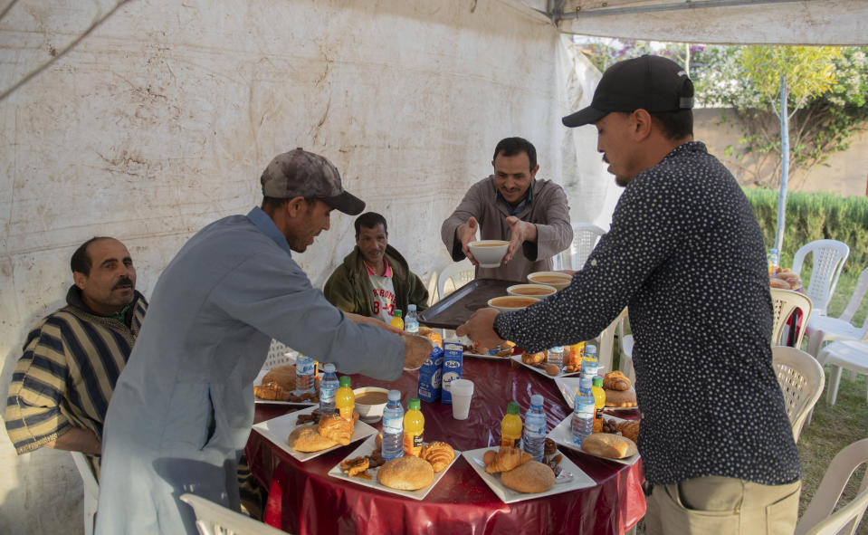 People who have been displaced by the earthquake prepare to host a group Iftar to break their Ramadan fast, in Amizmiz, near Marrakech, Thursday, April 4, 2024. (AP Photo)