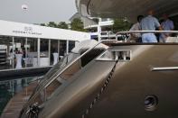 FILE PHOTO: Prospects inspect a Ferretti Riva yacht at the Singapore Yacht Show on Sentosa Island