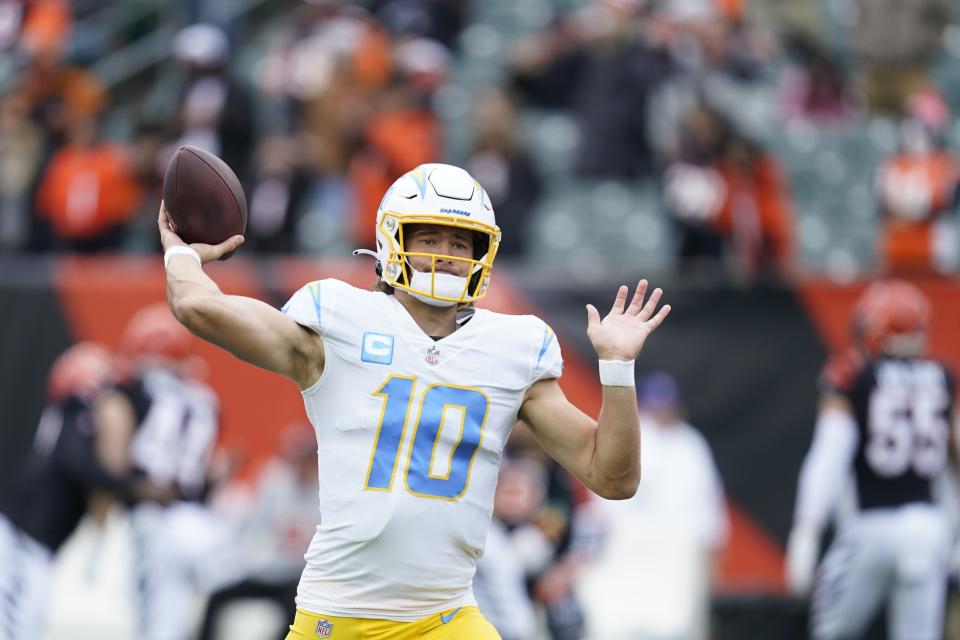 Los Angeles Chargers quarterback Justin Herbert throws before an NFL football game between the Cincinnati Bengals and the Los Angeles Chargers, Sunday, Dec. 5, 2021, in Cincinnati. (AP Photo/Michael Conroy)