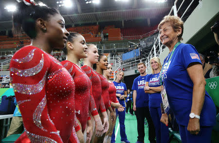 FILE PHOTO: U.S. Gymnasts L-R: Simone Biles, Laurie Hernandez, Madison Kocian, Gabby Douglas and Alexandra Raisman speak to team coordinator Marta Karolyi (R) during training at the 2016 Rio Olympics in Rio de Janeiro, Brazil, August 4, 2016. REUTERS/Damir Sagolj/File Photo