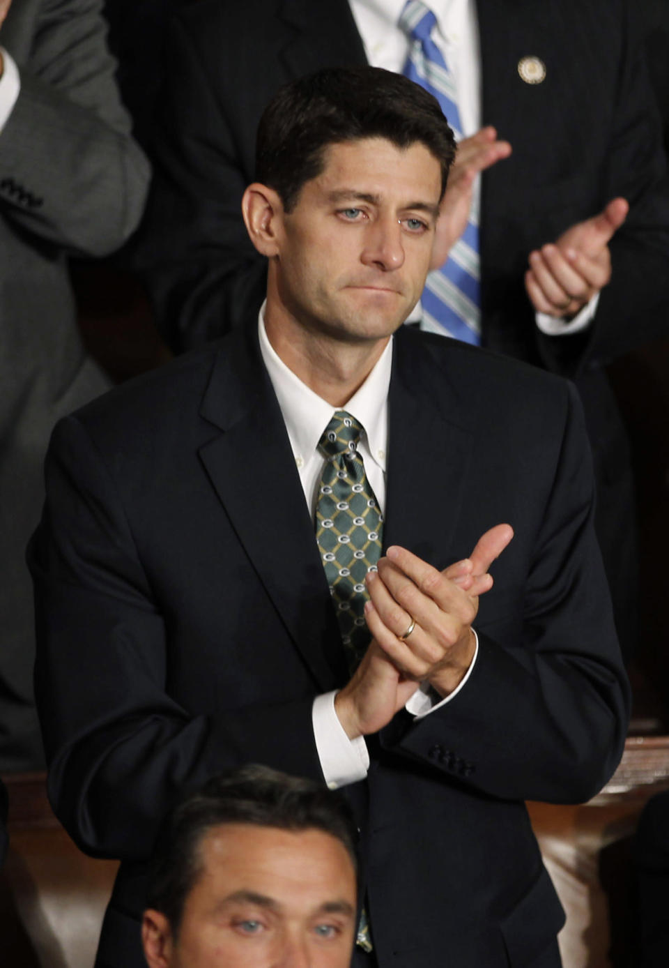 Rep. Paul Ryan (R-WI), Chairman of the U.S. House of Representatives Committee on the Budget, stands up and applauds remarks by U.S. President Barack Obama as he addresses a joint session of Congress on Capitol Hill in Washington September 8, 2011. REUTERS/Jason Reed