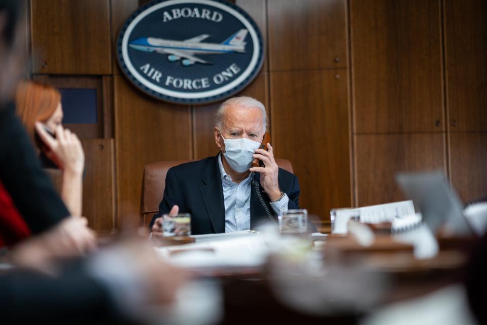 Joe Biden sits at a table on Air Force One