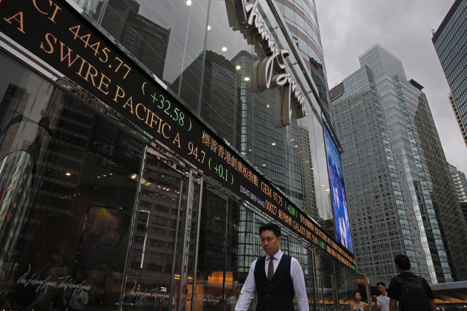 In this June 10, 2019, photo, people walk in front of the Hong Kong Exchange Square at Central, a business district of Hong Kong. It’s still the world’s “freest” economy, one of the biggest global financial centers and a scenic haven for tycoons and tourists, but the waves of protests rocking Hong Kong are exposing strains unlikely to dissipate as communist-ruled Beijing’s influence grows. (AP Photo/Kin Cheung)