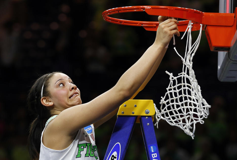 Notre Dame forward Natalie Achonwa reacts as she has difficulty removing the net from the rim after beating Baylor 88-69 in their NCAA women's college basketball tournament regional final game at the Purcell Pavilion in South Bend, Ind., Monday, March 31, 2014. (AP Photo/Paul Sancya)