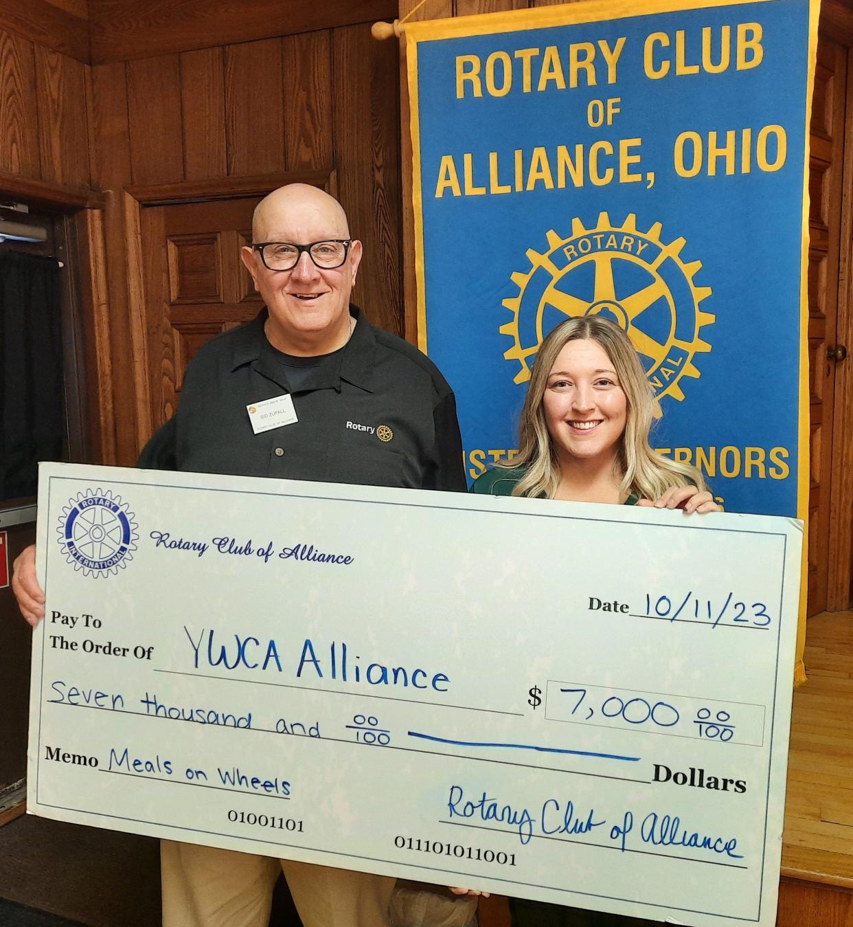 Korena Pow, right, an Alliance YWCA employee who coordinates the Meals on Wheels program, accepts a $7,000 check from Alliance Rotary Club President Sid Zufall at a recent club meeting. Pow spoke to the group about the program, and its impending financial issues.