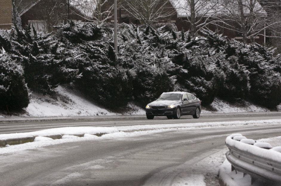 Snow and Ice cover the roadways making the morning commute difficult in downtown Columbia, S.C., Wednesday, Jan. 29, 2014. Gov. Nikki Haley declared a state of emergency in South Carolina as a winter storm brought snow, sleet and freezing rain into the state. Schools and state and local government are closed for a second day. (AP Photo/Mary Ann Chastain)