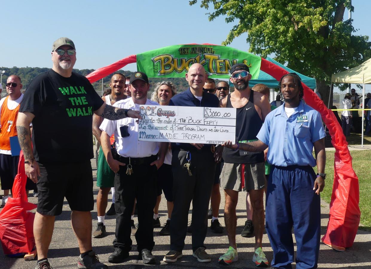 Groups at CCI raised $3,000 for the Made Program through the Buck Fifty. Chris Scott from the organization accepted the donation before the race.