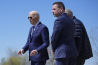 President Joe Biden, from left, walks with County Executive Ryan McMahon and Senate Majority Leader Chuck Schumer, D-N.Y., as he arrives at Hancock Field Air National Guard Base, Thursday, April 25, 2024, in Syracuse, N.Y. (AP Photo/Evan Vucci)