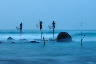 <b>Honorable Mention: Stilt Fishing</b> <br> Stilt fishing is a typical fishing technique only seen in Sri Lanka. The fishermen sit on a cross bar called a petta tied to a vertical pole planted into the coral reef. This long exposure shot shows how unstable their position is. <a href="http://ngm.nationalgeographic.com/ngm/photo-contest/" rel="nofollow noopener" target="_blank" data-ylk="slk:(Photo and caption by Ulrich Lambert/National Geographic Photo Contest);elm:context_link;itc:0;sec:content-canvas" class="link ">(Photo and caption by Ulrich Lambert/National Geographic Photo Contest)</a>