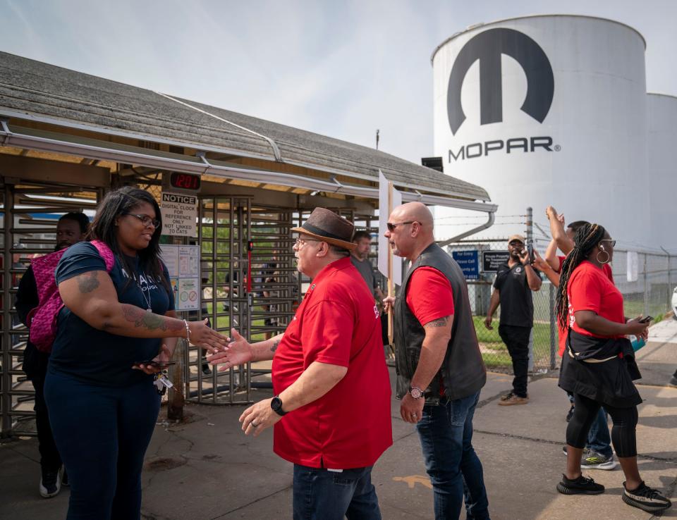 UWA Vice President head of Stellantis Department Rich Boyer, middle, greets strikers as they walk out at noon from Center Line Packaging as UAW President Shawn Fain called for more shops to go out on strike Friday, Sept. 22, 2023.