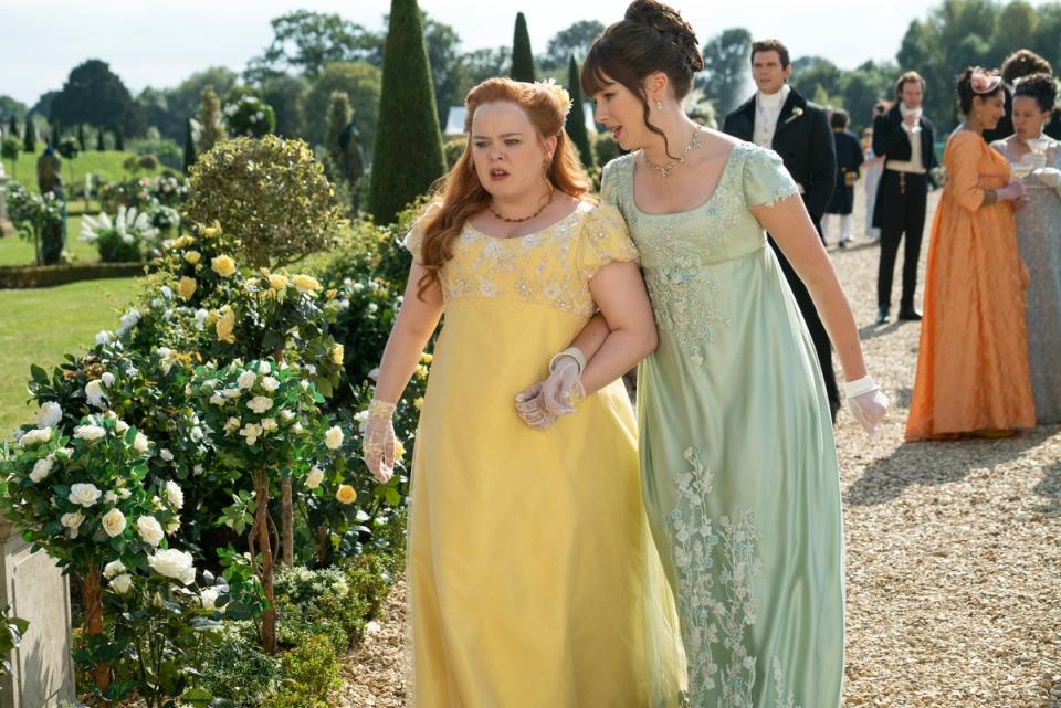 Penelope Featherington (Nicola Coughlan)  and Eloise (Claudia Jessie) strolling through the garden in wispy dresses (LIAM DANIEL/NETFLIX)