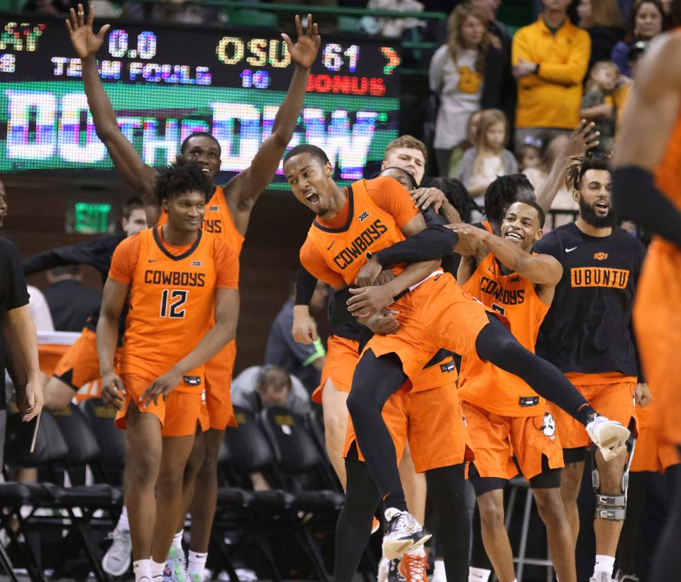 Oklahoma State guard Bryce Thompson is lifted up by teammates following their 61-54 win over No. 1 Baylor on Saturday in Waco, Texas.