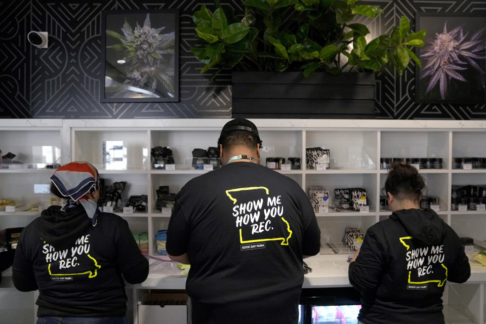 Employees, known as budtenders, from left to right, Chloe Wynn, Randy McFadden and Maria Colarelli prepare marijuana products at Good Day Farm dispensary Friday, Feb. 3, 2023, in St. Louis. Recreational marijuana sales were allowed to begin on Friday in Missouri after the state's health department gave approval. (AP Photo/Jeff Roberson)