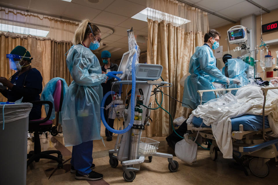 Health care workers tend to a COVID-19 patient at Providence St. Mary Medical Center in Apple Valley, Calif., in January this year. 