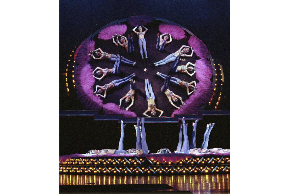 FILE - In this April 14, 1997, file photo, showgirls perform one of their acts during a dress rehearsal for the new edition of "The Best of the Folies Bergere...Sexier Than Ever" show at the Tropicana Resort and Casino in Las Vegas. (AP Photo/Lennox McLendon, file)