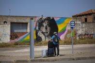 Biram Fall, 52 year-old migrant from Senegal waits for a bus in Alcarraz, to go to the city of Lleida, Spain, Thursday, July 2, 2020. Authorities in northeast Spain have ordered the lockdown of a county around the city of Lleida due to worrying outbreaks of the COVID-19 virus. Catalan regional authorities announced Saturday, July 4, 2020 that as of noon local time movement will be restricted to and from the county of El Segriá around Lleida which is home to over 200,000 people. Residents will have until 4 p.m. to enter the area. The new outbreaks are linked to agricultural workers in the rural area. (AP Photo/Emilio Morenatti)