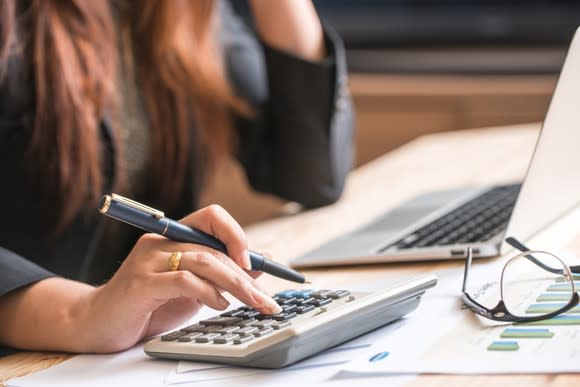 Woman using a calculator.