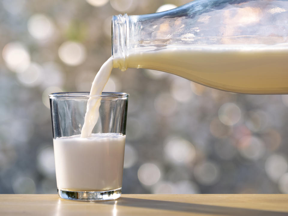 soy milk being poured into a cup