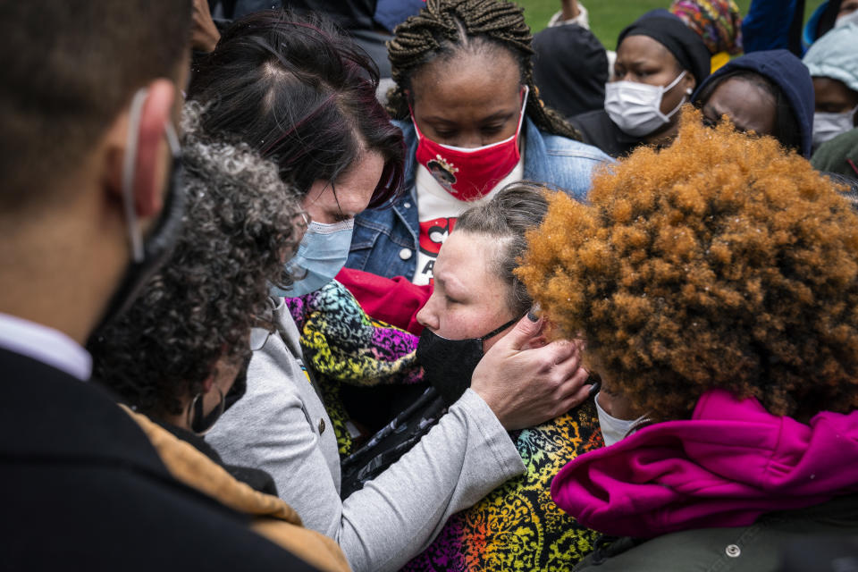 Katie Wright, center right, the mother of Daunte Wright, is embraced by George Floyd's girlfriend, Courteney Ross, center left, before a news conference outside the Hennepin County Government Center on Tuesday, April 13, 2021, in Minneapolis. (Leila Navidi/Star Tribune via AP)