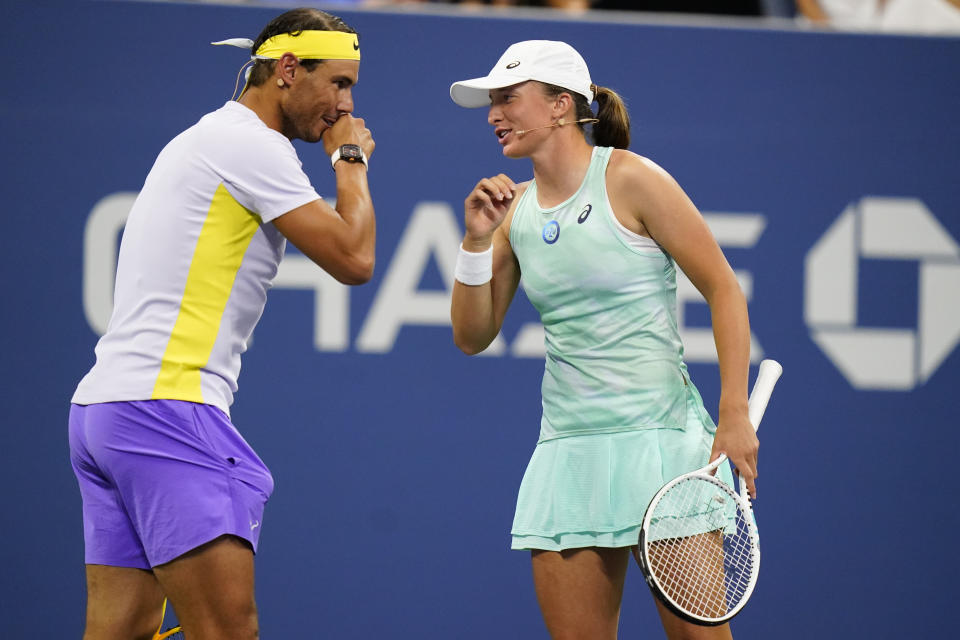 Rafael Nadal, of Spain, left, speaks to Iga Swiatek, of Poland, during "The Tennis Plays for Peace" exhibition match to raise awareness and humanitarian aid for Ukraine Wednesday, Aug. 24, 2022, in New York. The 2022 U.S. Open Main Draw will begin on Monday, Aug. 29, 2022. (AP Photo/Frank Franklin II)