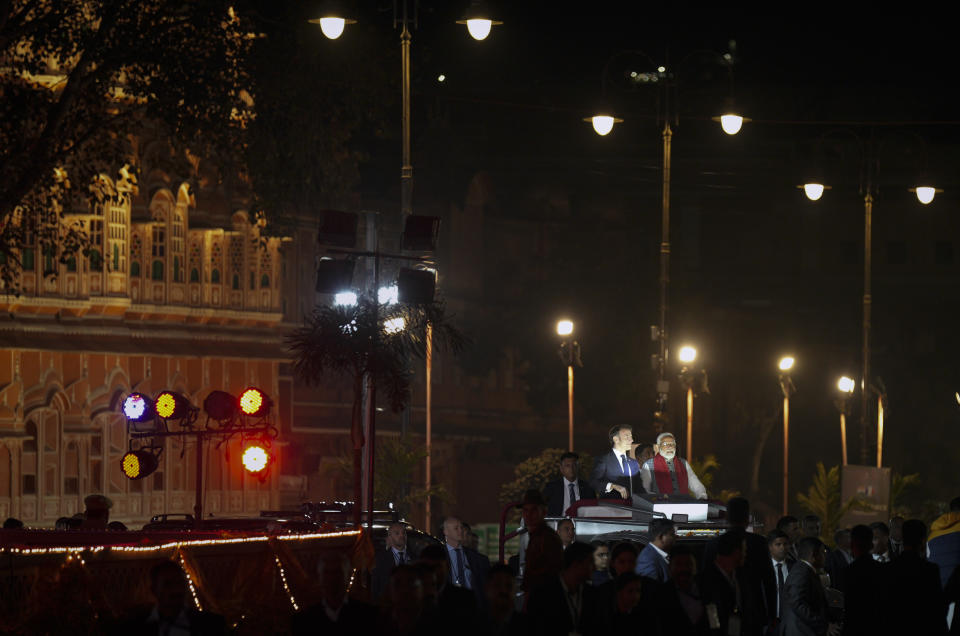 French President Emmanuel Macron, left, and Indian Prime Minister Narendra Modi ride an open vehicle together during a road show in Jaipur, Rajasthan, India, Thursday, Jan. 25, 2024. Macron will be the chief guest at India's annual republic day parade in New Delhi on Friday. (AP Photo/ Deepak Sharma)