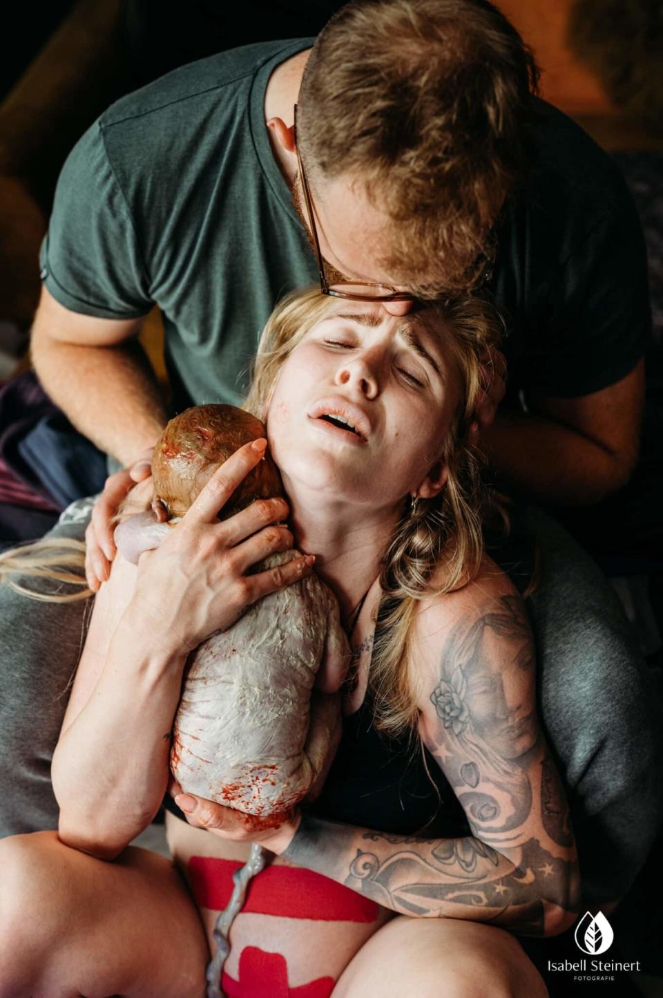 A parent comforting their child wrapped in a towel, both showing relief and affection