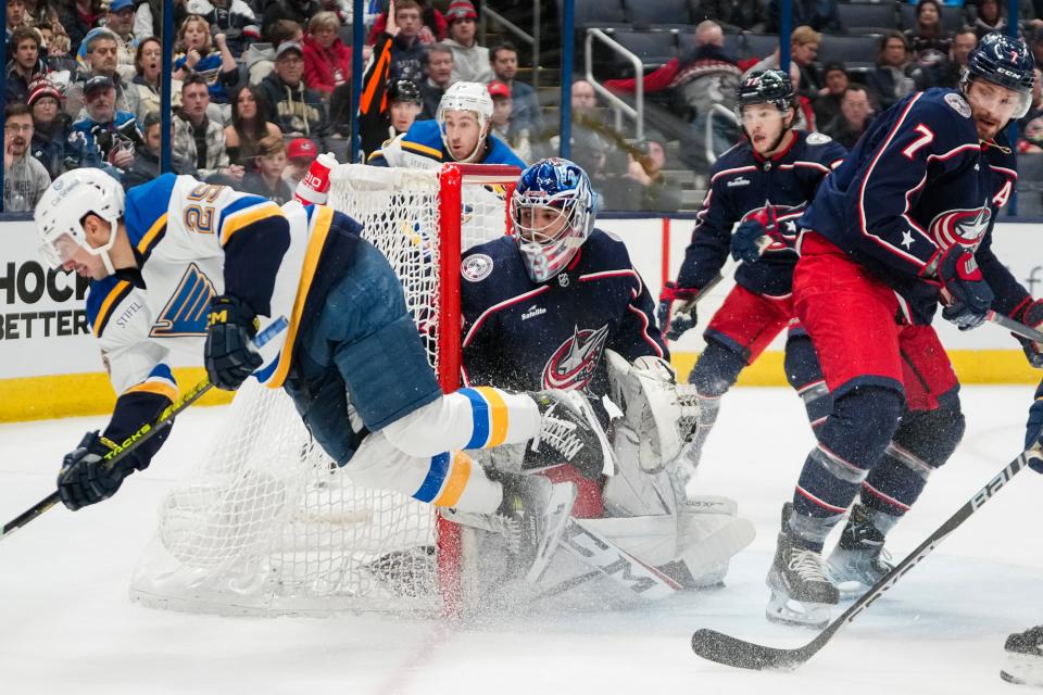 Dec 8, 2023; Columbus, Ohio, USA; Columbus Blue Jackets goaltender Jet Greaves (73) makes a save as St. Louis Blues center Jordan Kyrou (25) goes flying after a slash by Columbus Blue Jackets center Sean Kuraly (7) during the second period of the NHL game at Nationwide Arena.