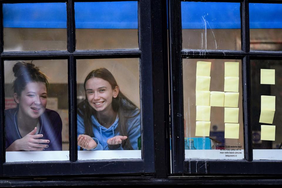 Glasgow University students look out of the windows of campus accommodation in Murano Street (Getty Images)