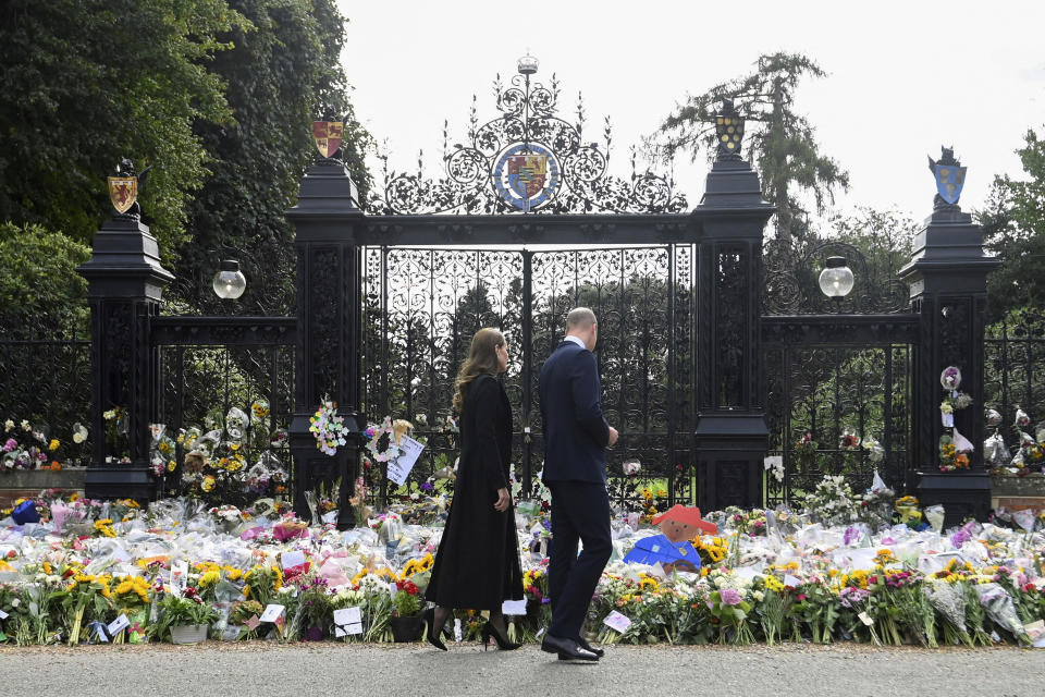 Britain's William, Prince of Wales and Kate, Princess of Wales view floral tributes left by members of the public, in memory of late Queen Elizabeth II, at the Sandringham Estate, in Norfolk, England, Thursday, Sept. 15, 2022. Queen Elizabeth II, Britain's longest-reigning monarch died Thursday Sept. 8, 2022, after 70 years on the throne. (Toby Melville/Pool via AP)