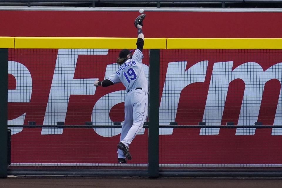 Colorado Rockies right fielder Charlie Blackmon leaps in vain for an RBI triple by Arizona Diamondbacks' Eduardo Escobar during the third inning of the first game of a baseball doubleheader Friday, Sept. 25, 2020, in Phoenix. (AP Photo/Ross D. Franklin)