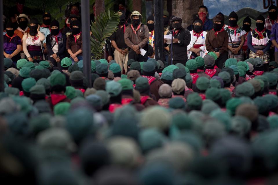 Members of the Zapatista National Liberation Army (EZLN) attend an event marking the 25th anniversary of the Zapatista uprising in La Realidad, Chiapas, Mexico, Monday, Dec. 31, 2018. (AP Photo/Eduardo Verdugo)