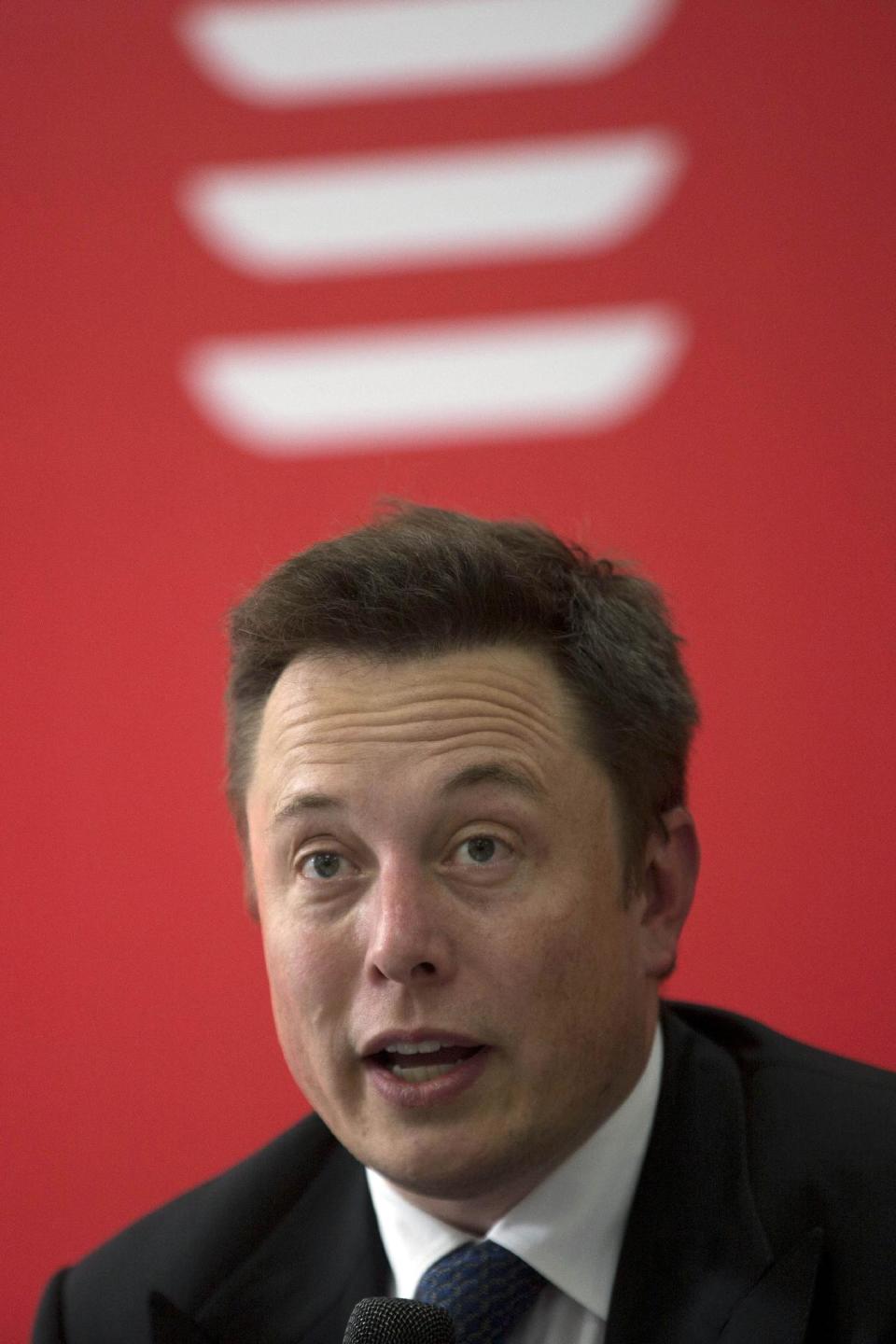 Tesla Motors Inc. CEO Elon Musk speaks before an event to deliver the first set of sedans to customers in Beijing, China, Tuesday, April 22, 2014. Tesla Motors delivered its first eight electric sedans to customers in China on Tuesday and Musk said the company will build a nationwide network of charging stations and service centers as fast as it can. (AP Photo/Ng Han Guan)