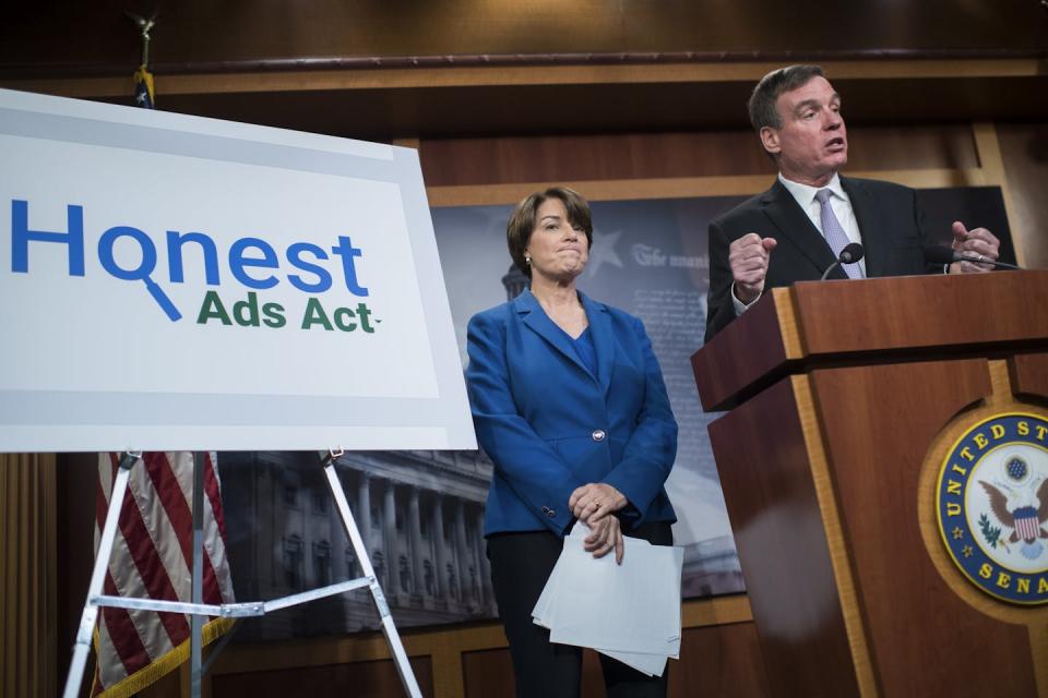 Sens. Amy Klobuchar, D-Minn., and Mark Warner, D-Va., introduced the Honest Ads Act in 2017. <a href="https://www.gettyimages.com/detail/news-photo/sens-amy-klobuchar-d-minn-and-mark-warner-d-va-conduct-a-news-photo/863084460" rel="nofollow noopener" target="_blank" data-ylk="slk:Tom Williams/CQ Roll Call via Getty Images;elm:context_link;itc:0;sec:content-canvas" class="link ">Tom Williams/CQ Roll Call via Getty Images</a>