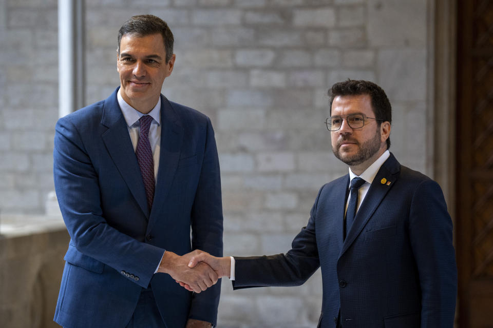 Spanish Prime Minister Pedro Sanchez, left, shakes hands with Catalonia's President Pere Aragones during a meeting in Barcelona, Spain, Thursday, Dec. 21, 2023. Sanchez and Aragones meet in the first encounter since an amnesty for Catalan separatists was announced earlier this year. (AP Photo/Emilio Morenatti)