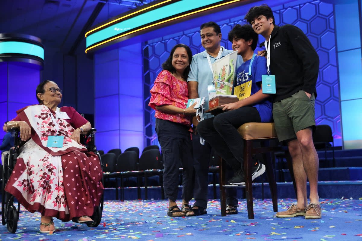 Dev Shah, 14, holds the trophy accompanied by his father Deval Shah, his mother Nilam Shah, his brother Neil Shah and his grandmother Vinaben Shah (REUTERS)