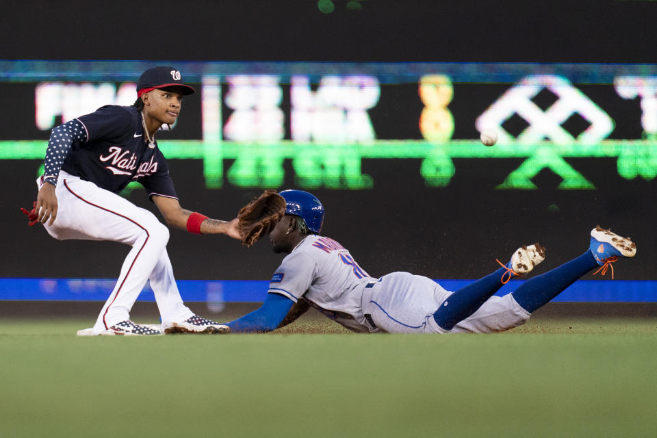 New York Mets' Ronny Mauricio, right, steals second base in front of Washington Nationals shortstop CJ Abrams, left, during the second inning of a baseball game, Wednesday, Sept. 6, 2023, in Washington. (AP Photo/Stephanie Scarbrough)