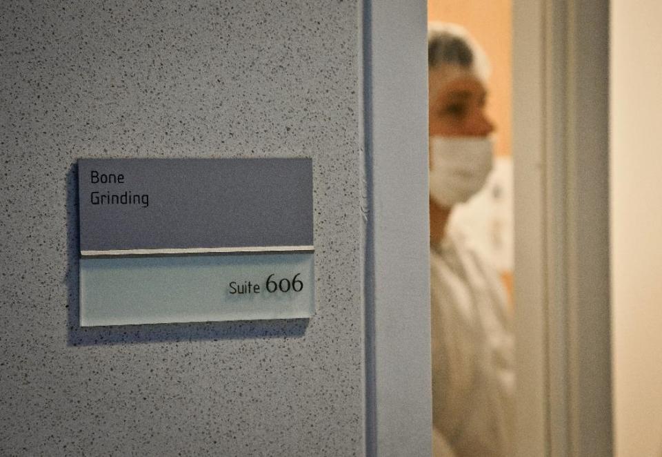 In this April 15, 2014 photo, Michael Mosco, a criminalist, prepares to enter the bone grinding room at the Office of Chief Medical Examiner in New York. The room is central to the examination of bone DNA from those who died on Sept. 11, 2001. Forensic scientists are still trying to match the bone with DNA from victims who have never been identified. The resting place for thousands of vacuum-sealed plastic pouches with remains of the victims are to be moved to the new trade center site Saturday, May 10. (AP Photo/Bebeto Matthews)