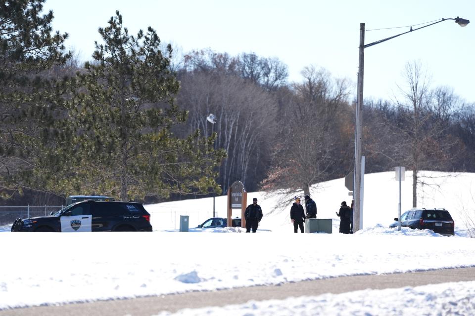 Law enforcement officials arrive to the scene of a shooting of two police officers and a first responder on Feb. 18, 2024, in Burnsville, Minn.