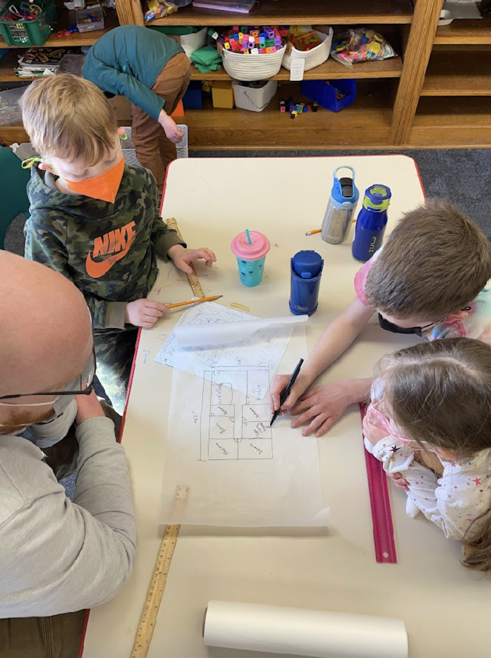 Students at Limestone Community School in Lawrence, Kan., work on drawing a design for one of the four homes they plan to have built for people in need of housing.