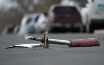 A part from a United Airlines jetliner sits in the middle of Elmwood Street in the street near a home peppered by parts from a plane as it was making an emergency landing at nearby Denver International Airport Saturday, Feb. 20, 2021. (AP Photo/David Zalubowski)