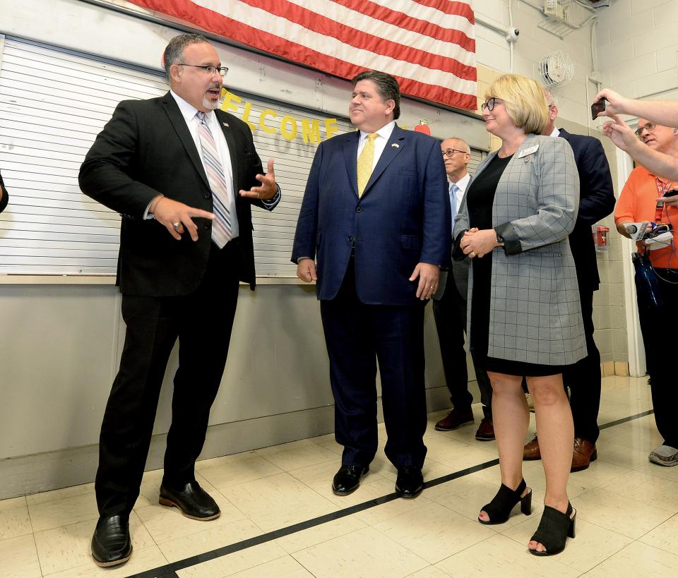 U.S. Secretary of Education Miguel Cardona, left, speaks with Illinois Gov. JB Pritzker, center, and District 186 Superintendent Jennifer Gill, right, during a stop at Fairview Elementary School Wednesday, Sept. 6, 2023.