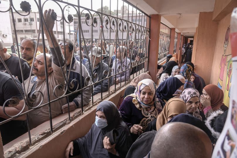 Egyptian voters line up to cast their votes for the presidential elections at a polling station, in Cairo, Egypt on Sunday