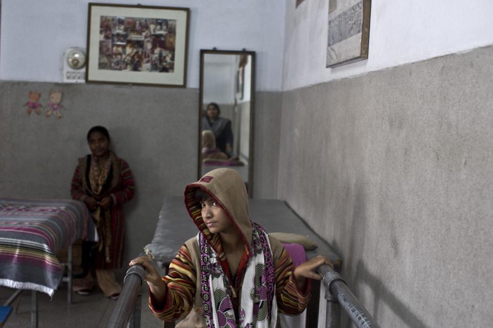 In this Saturday, Feb. 15, 2014, photo, Hina Pal, 26, a Pakistani patient, who suffers a spinal cord injury, and a resident at St. Joseph’s Hospice, attends her daily physiotherapy session where she practices to stand for two hours a day, 6 days a week, at the hospice in Rawalpindi, Pakistan. Mohammed Aqeel spent weeks at home in Pakistan waiting for death after suffering a debilitating spinal cord injury in a car crash before friends suggested he come to St. Joseph’s Hospice on the outskirts of the capital, Islamabad. Now 13 years later, his life and those of some 40 others who live on its grounds might be changed forever as this hospital of last resort faces closure over its rising debts. (AP Photo/Muhammed Muheisen)