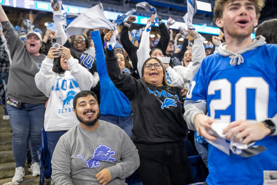 Jesus Preciado, 27, of Lincoln Park, and Jitcel Tellez-Luz, 22, of Detroit, cheer after the Detroit Lions scored a touchdown in the second quarter, during the Detroit Lions NFC Championship watch party at Ford Field in Detroit on Sunday, Jan. 28, 2024.