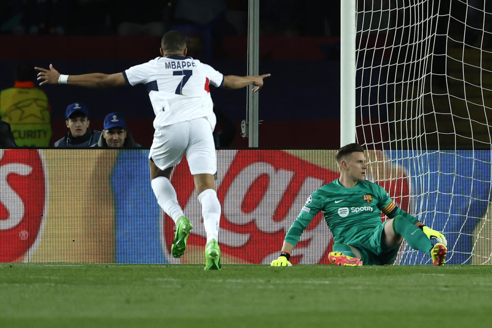 PSG's Kylian Mbappe scores his side's 3rd goal on a penalty kick during the Champions League quarterfinal second leg soccer match between Barcelona and Paris Saint-Germain at the Olimpic Lluis Companys stadium in Barcelona, Spain, Tuesday, April 16, 2024. (AP Photo/Joan Monfort)