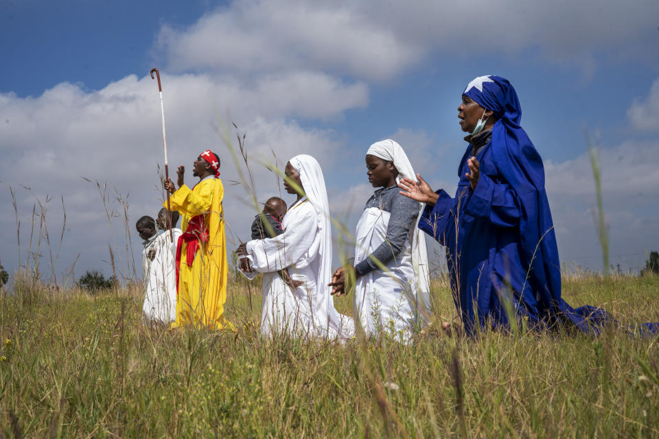 Apostolic Pentecostals celebrate Easter in field in the Johannesburg township of Soweto Sunday April 4, 2021. Such South African independent church consist of small groups of worshippers mixing African traditions and bible study. (AP Photo/Jerome Delay)