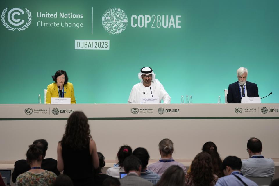 Sconaid McGeachin, director of communications and marketing for COP28, from left, COP28 President Sultan al-Jaber, Jim Skea, chair of the Intergovernmental Panel on Climate Change, attend a news conference at the COP28 U.N. Climate Summit, Monday, Dec. 4, 2023, in Dubai, United Arab Emirates. (AP Photo/Kamran Jebreili)