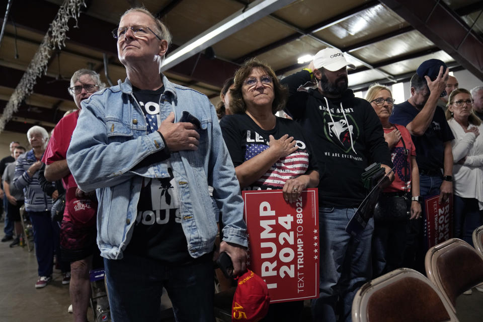 Supporters of former President Donald Trump stand for the national anthem during a commit to caucus rally, Wednesday, Sept. 20, 2023, in Maquoketa, Iowa. (AP Photo/Charlie Neibergall)