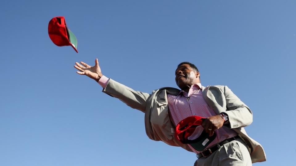 <div class="inline-image__caption"><p>"Herschel Walker throws a cap during a rally held by Donald Trump in Commerce, Georgia, on March 26.</p></div> <div class="inline-image__credit">Alyssa Pointer/Reuters</div>