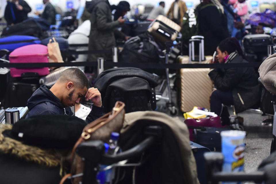 Passengers stranded at Gatwick airport, as the airport remains closed after drones were spotted over the airfield last night and this morning, in Gatwick, England, Thursday, Dec. 20, 2018. Drones spotted over the runway forced the shutdown of London's Gatwick Airport on Thursday during one of the busiest times of the year, stranding or delaying tens of thousands of Christmas-season travelers and setting off a hunt for the operator of the intruding aircraft. (Victoria Jones/PA via AP)